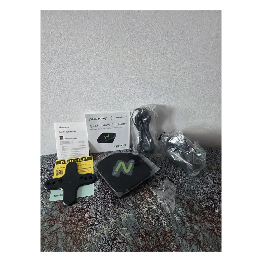 NComputing L300 thin client unboxed with VESA bracket, power supply, cords and quick installation guide